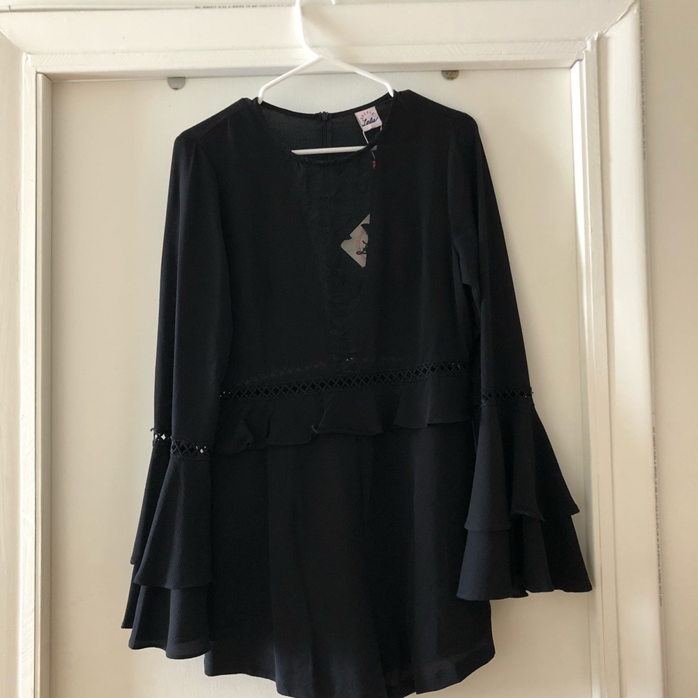 Black romper with see through plunging neck